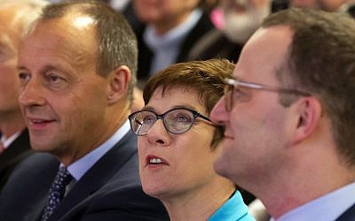 In this Wednesday, November 21, 2018 file photo, Friedrich Merz, former German Christian Democratic Union faction leader, left, Annegret Kramp-Karrenbauer, General Secretary of the CDU, and Germany's Health Minister Jens Spahn, right, all members of the CDU, attend a party regional conference candidates for the CDU chairmanship in Seebach, central Germany. (AP Photo/Jens Meyer, file)