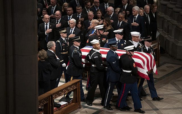 The flag-draped casket of former President George H.W. Bush is carried by a military honor guard past former President George W. Bush and wife Laura Bush, President Donald Trump, first lady Melania Trump, former President Barack Obama, Michelle Obama, former President Bill Clinton, former Secretary of State Hillary Clinton, former President Jimmy Carter, and Rosalynn Carter during a State Funeral at the National Cathedral, Wednesday, Dec. 5, 2018, in Washington. (AP Photo/Carolyn Kaster) The flag-draped casket of former President George H.W. Bush is carried by a military honor guard past former President George W. Bush and wife Laura Bush, President Donald Trump, first lady Melania Trump, former President Barack Obama, Michelle Obama, former President Bill Clinton, former Secretary of State Hillary Clinton, former President Jimmy Carter, and Rosalynn Carter during a State Funeral at the National Cathedral, Wednesday, Dec. 5, 2018, in Washington. (AP Photo/Carolyn Kaster)