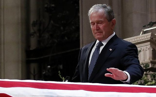 Former president George W. Bush touches the casket of his father, former president George H.W. Bush, at the State Funeral at the National Cathedral, Wednesday, Dec. 5, 2018, in Washington.(AP Photo/Alex Brandon, Pool) Former president George W. Bush touches the casket of his father, former president George H.W. Bush, at the State Funeral at the National Cathedral, Wednesday, Dec. 5, 2018, in Washington.(AP Photo/Alex Brandon, Pool)