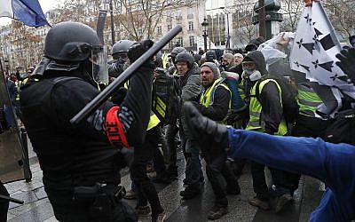 Police officers clash with demonstrators wearing yellow vests in Paris on December 8, 2018 (AP Photo/Thibault Camus)