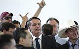 Brazil's president-elect Jair Bolsonaro, center, poses for photos during a lunch with popular singers who supported his campaign, at the Army Club, in Brasilia, Brazil, Tuesday, Dec. 11, 2018. (AP/Eraldo Peres)