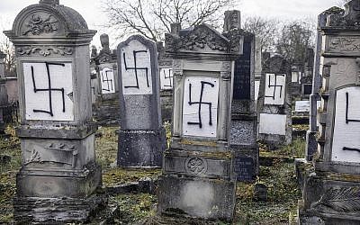 Jewish tombstones are seen desecrated with swastikas in the Herrlisheim Jewish cemetery, north of Strasbourg, eastern France, December 13, 2018. (AP Photo/Jean-Francois Badias)