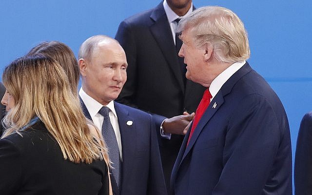 In this photo from November 30, 2018, US President Donald Trump, right, walks past Russia's President Vladimir Putin, left, as they gather for the group photo at the start of the G20 summit in Buenos Aires, Argentina. (AP Photo/Pablo Martinez Monsivais, File In this photo from November 30, 2018, US President Donald Trump, right, walks past Russia's President Vladimir Putin, left, as they gather for the group photo at the start of the G20 summit in Buenos Aires, Argentina. (AP Photo/Pablo Martinez Monsivais, File