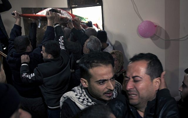 Relatives of 16 year-old Palestinian Mohammed Jahjouh, who was said to have been shot and killed by Israeli troops during a protest at the Gaza Strip's border with Israel, mourn as others carry his body into the family home during his funeral in Gaza City, December 22, 2018. (AP Photo/Khalil Hamra) Relatives of 16 year-old Palestinian Mohammed Jahjouh, who was said to have been shot and killed by Israeli troops during a protest at the Gaza Strip's border with Israel, mourn as others carry his body into the family home during his funeral in Gaza City, December 22, 2018. (AP Photo/Khalil Hamra)