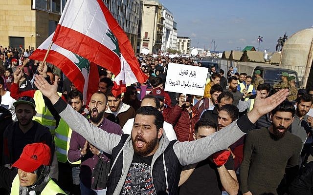 Lebanese anti-government protesters chant slogans during a protest in downtown Beirut, Lebanon, Dec. 23, 2018  (AP Photo/Bilal Hussein)