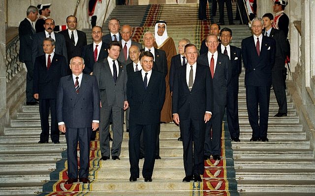 From left front, Soviet President Mikhail Gorbachev, Spanish Premier Felipe Gonzales and US President George H.W. Bush pose in front of delegates at the end of the first session of the Middle East peace conference held in the Palacio Real in Madrid, Spain, on October 30, 1991. (AP Photo/Jerome Delay) From left front, Soviet President Mikhail Gorbachev, Spanish Premier Felipe Gonzales and US President George H.W. Bush pose in front of delegates at the end of the first session of the Middle East peace conference held in the Palacio Real in Madrid, Spain, on October 30, 1991. (AP Photo/Jerome Delay)