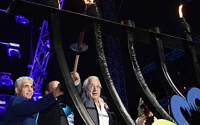 US Ambassador David Friedman, left, lighting a Hanukkah menorah, at the Sultan's Pool in Jerusalem, on December 3, 2018. (Matty Stern/ US Embassy)