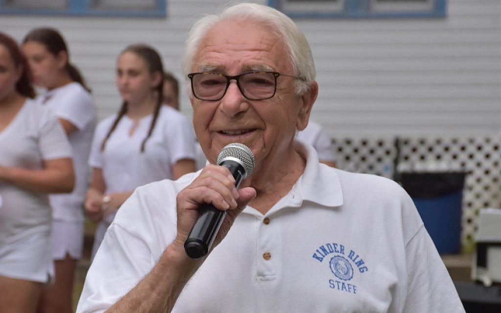 Mikhl Baran, who leads Jewish culture programming at Camp Kinder Ring, speaking at a Friday evening program. (Sharon Strongin/Camp Kinder Ring/via JTA)