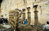 View of Hanukkah menorah on the last night of the eight-day Jewish festival at the Western Wall in Jerusalem Old City, December 19, 2017. (Mendy Hechtman/Flash90)