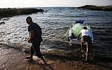 An illustrative photo of people fishing legally at Achziv Beach in northern Israel, on July 3, 2018. (David Cohen/Flash90)