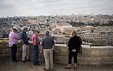 Tourists listen to a tourguide on the lookout of the Mount of Olives overlooking the Old city of Jerusalem, on October 11, 2018. (Hadas Parush/Flash90)