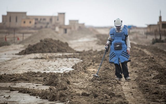 A man searches for mines near the site of Qasr al Yahud, the place where Jesus is believed to have been baptized, near the West Bank town of Jericho, on December 9, 2018. (Hadas Parush/Flash90) A man searches for mines near the site of Qasr al Yahud, the place where Jesus is believed to have been baptized, near the West Bank town of Jericho, on December 9, 2018. (Hadas Parush/Flash90)
