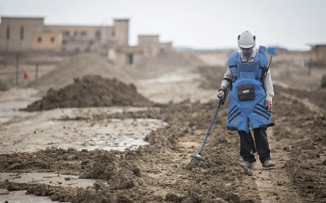 A man searches for mines near the site of Qasr al Yahud, the place where Jesus is believed to have been baptized, near the West Bank town of Jericho, on December 9, 2018. (Hadas Parush/Flash90) A man searches for mines near the site of Qasr al Yahud, the place where Jesus is believed to have been baptized, near the West Bank town of Jericho, on December 9, 2018. (Hadas Parush/Flash90)