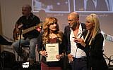 Likud MK Nava Boker, left, singer Eyal Golan, and celebrity businesswoman Pnina Rosenblume during a ceremony to award Golan with a prize for his contribution to music, held at the Knesset, Jerusalem  on December 11, 2018, and which was interrupted by activists arguing that Golan shouldn't receive any award due to the allegations made against him (Hadas Parush/Flash90)