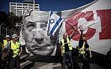 A poster of Prime Minister Benjamin Netanyahu is seen, as "yellow vest" protests reach Israel with hundreds marching against the rising cost of living in central Tel Aviv on December 14, 2018. (Miriam Alster/Flash90)