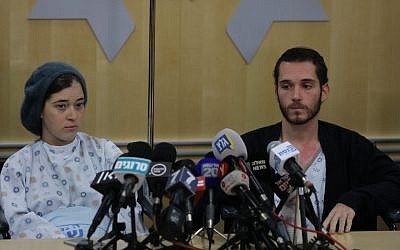 Shira (left) and Amichai Ish-Ran, both injured on December 9, 2018 when a Palestinian terrorist opened fire on Israelis near the settlement of Ofra, hold a press conference at the Shaare Zedek hospital in Jerusalem on December 16, 2018. (Yonatan Sindel/FLASH90)