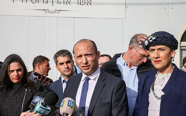Education Minister and leader of the Jewish Home party Naftali Bennett speaks with the media as he arrives for a special faction meeting in the Israeli outpost of Givat Assaf, in the West Bank on December 17, 2018. (Yonatan Sindel/Flash90) Education Minister and leader of the Jewish Home party Naftali Bennett speaks with the media as he arrives for a special faction meeting in the Israeli outpost of Givat Assaf, in the West Bank on December 17, 2018. (Yonatan Sindel/Flash90)