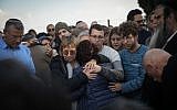 Friends and family mourn by the grave of author Amos Oz during a his funeral in Kibbutz Hulda, on December 31, 2018. (Hadas Parush/ Flash90)