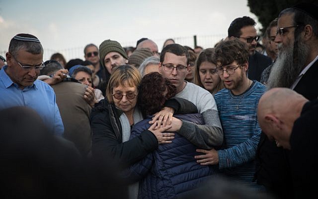 Friends and family mourn by the grave of author Amos Oz during a his funeral in Kibbutz Hulda, on December 31, 2018. (Hadas Parush/ Flash90) Friends and family mourn by the grave of author Amos Oz during a his funeral in Kibbutz Hulda, on December 31, 2018. (Hadas Parush/ Flash90)