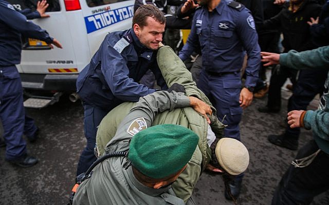 Right wing activists clash with police outside a court hearing in Rishon Lezion, on the matter of the Jewish youth suspects in a major security probe whose details are under gag order on December 31, 2018. (Flash90) Right wing activists clash with police outside a court hearing in Rishon Lezion, on the matter of the Jewish youth suspects in a major security probe whose details are under gag order on December 31, 2018. (Flash90)