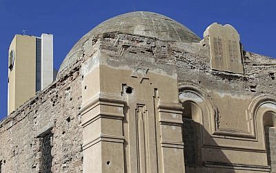 A hotel can be seen behind the abandoned Dar Bishi synagogue in Tripoli, Libya, September 28, 2011. (Joseph Eid/AFP/Getty Images via JTA)