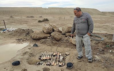 Moshe Hilman, the supervisor of the Israel National Mine Action Authority's Qasr al Yahud site, points at unexploded ordinance found in the compound of the Ethiopian Church on December 9, 2018. (Melanie Lidman/Times of Israel)