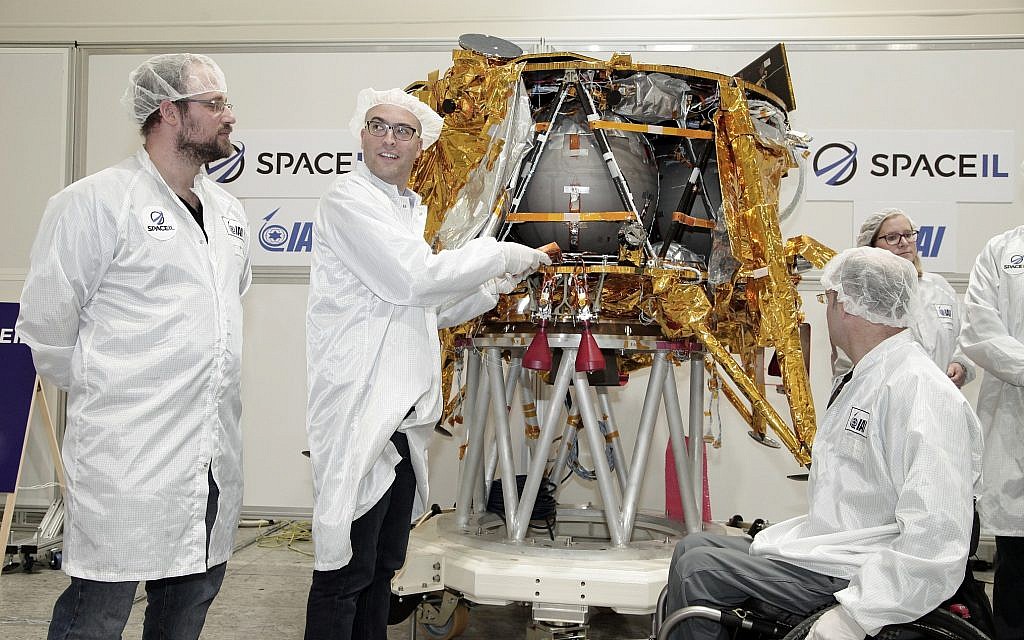 Yariv Bash, right, Yonatan Winetraub, middle, and Kfir Damari, the founders of SpaceIL, inserting a digital time capsule into the Beresheet spacecraft, December 17, 2018. (Yoav Weiss) Yariv Bash, right, Yonatan Winetraub, middle, and Kfir Damari, the founders of SpaceIL, inserting a digital time capsule into the Beresheet spacecraft, December 17, 2018. (Yoav Weiss)