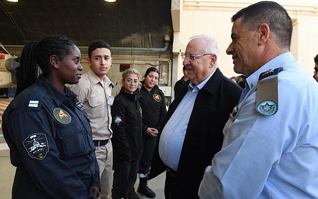 President Reuven Rivlin lights the third candle of Hanukkah with the IAF's 25th Wing at the Ramon Air Force base in southern Israel on December 4, 2018. (Mark Neiman/GPO) President Reuven Rivlin lights the third candle of Hanukkah with the IAF's 25th Wing at the Ramon Air Force base in southern Israel on December 4, 2018. (Mark Neiman/GPO)