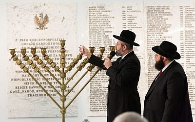 Rabbi David Lau, chief Ashkenazi rabbi of Israel, lights Hanukkah candles in the Sejm, the lower house of Poland’s Parliament, on Dec. 5, 2018. (Eli Mandelbaum via JTA)