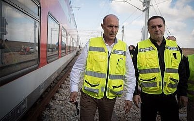 Israel Railways CEO Shahar Ayalon, center, with Israeli Minister of Transportation Israel Katz, right, during a test drive of the Jerusalem-Tel Aviv express train in central Israel, January 16, 2018. (Hadas Parush/Flash90)