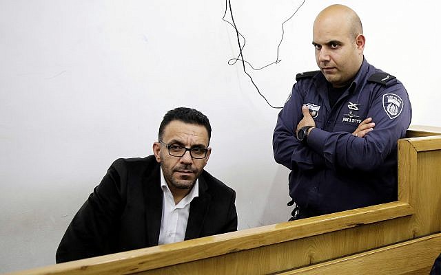 An Israeli policeman watches over the Palestinian Authority's Jerusalem governor, Adnan Ghaith, during a court appearance following his arrest in Jerusalem, November 29, 2018. (AP Photo/Mahmoud Illean) An Israeli policeman watches over the Palestinian Authority's Jerusalem governor, Adnan Ghaith, during a court appearance following his arrest in Jerusalem, November 29, 2018. (AP Photo/Mahmoud Illean)
