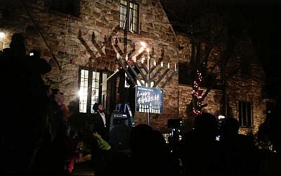 Members of ZBT fraternity of Penn State light their menorah on the first night of Hannukah, December 2, 2018. (Facebook screenshot)