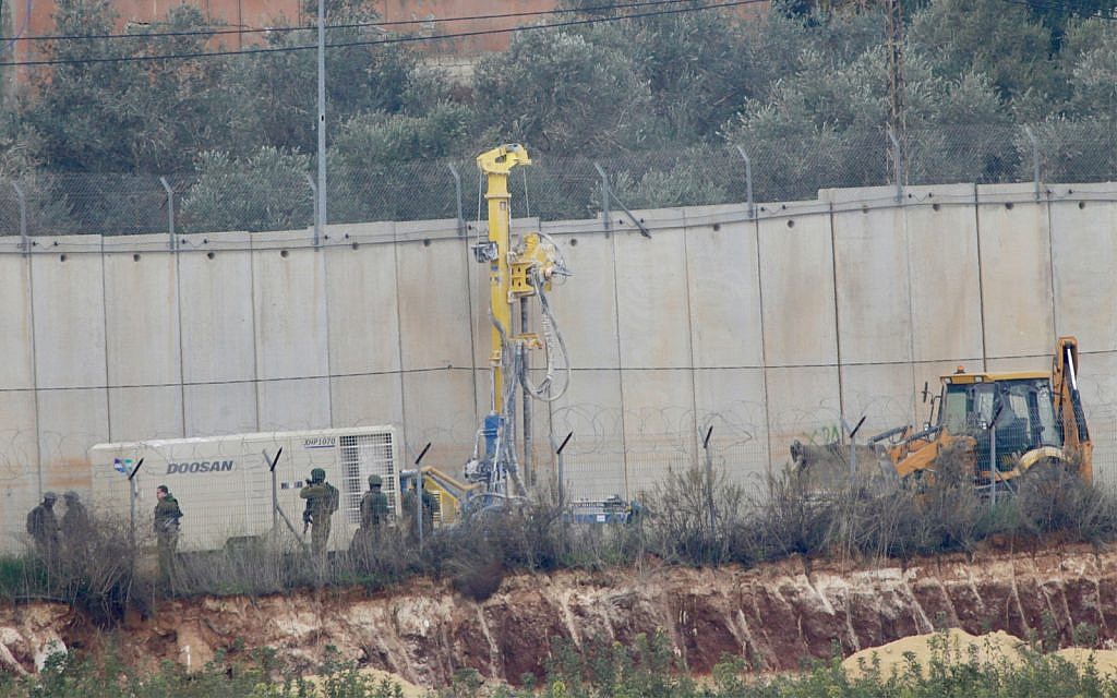 Israeli military digger works on the border with Lebanon in the northern Israeli town of Metula, Tuesday, Dec. 4, 2018. (AP Photo/Ariel Schalit)