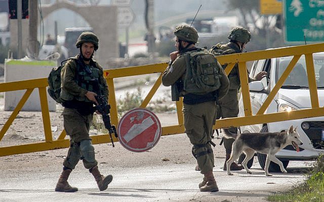 Israeli soldiers near the attempted car-ramming attack against a group of Israeli soldiers and civilians near the entrance to Nablus, December 26, 2018. (Nasser Ishtayeh/Flash90) Israeli soldiers near the attempted car-ramming attack against a group of Israeli soldiers and civilians near the entrance to Nablus, December 26, 2018. (Nasser Ishtayeh/Flash90)