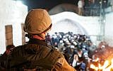 Illustrative: Israeli soldiers escort hundreds of Jewish worshippers to the Joseph's Tomb holy site in Nablus in the northern West Bank on December 10, 2018. (Israel Defense Forces)