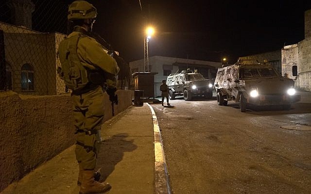 Israeli soldiers search for gunmen who opened fire at a bus stop outside the West Bank settlement of Ofra, injuring seven people, on December 9, 2018. (Israel Defense Forces) Israeli soldiers search for gunmen who opened fire at a bus stop outside the West Bank settlement of Ofra, injuring seven people, on December 9, 2018. (Israel Defense Forces)
