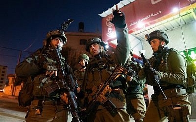 Israeli troops search for the terrorists who committed a shooting attack on a bus stop outside the Ofra settlement in the West Bank, near Ramallah, in which seven Israelis were injured, including a pregnant woman, on December 9, 2018. (Israel Defense Forces)
