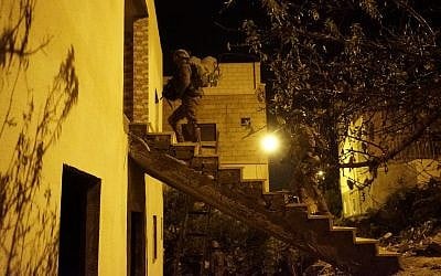 Israeli soldiers conduct raids in the West Bank village of Kobar on December 31, 2018, in search of Palestinian terrorists who committed a deadly shooting attack outside the Givat Assaf outpost earlier in the month. (Israel Defense Forces)