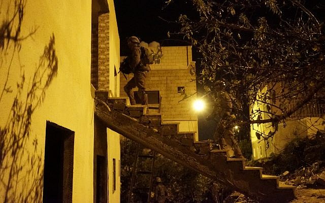 Israeli soldiers conduct raids in the West Bank village of Kobar on December 31, 2018, in search of Palestinian terrorists who committed a deadly shooting attack outside the Givat Assaf outpost earlier in the month. (Israel Defense Forces) Israeli soldiers conduct raids in the West Bank village of Kobar on December 31, 2018, in search of Palestinian terrorists who committed a deadly shooting attack outside the Givat Assaf outpost earlier in the month. (Israel Defense Forces)