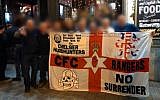Chelsea English Premier League soccer fans from the "headhunters," an extremist fan group known for hooliganism, in Budapest on December 13, 2018, holding a banner with a depiction of the SS-Totenkopf, a skull and bones graphic used by the Nazis. (Twitter screen capture)