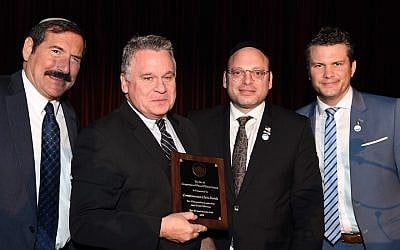 Rep. Chris Smith holds an award he received at the 36th annual Bet El gala dinner in New York, Dec. 2, 2018. Joining Smith, from left, are Dr. Joseph Frager, Duvi Honig and Pete Hegseth, co-host of “Fox and Friends.” (Courtesy of American Friends of the Bet El Yeshiva Center) Rep. Chris Smith holds an award he received at the 36th annual Bet El gala dinner in New York, Dec. 2, 2018. Joining Smith, from left, are Dr. Joseph Frager, Duvi Honig and Pete Hegseth, co-host of “Fox and Friends.” (Courtesy of American Friends of the Bet El Yeshiva Center)