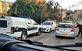 Illustrative: The scene of a drive-by shooting in the Arab Israeli town of Umm al-Fahm that left a 14-year-old boy wounded on December 26, 2018. The white car in the center was the target of the shooting, police said. (Hadashot TV screen capture)