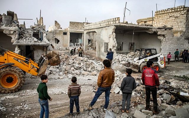 Members of the Syrian Civil Defense ('The White Helmets') use a bulldozer to remove debris from buildings damaged by reported airstrikes in the rebel-held town of Orum al-Kubra, in the northern Syrian province of Aleppo, on January 5, 2019 (Photo by Aaref WATAD / AFP) Members of the Syrian Civil Defense ('The White Helmets') use a bulldozer to remove debris from buildings damaged by reported airstrikes in the rebel-held town of Orum al-Kubra, in the northern Syrian province of Aleppo, on January 5, 2019 (Photo by Aaref WATAD / AFP)