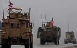 This file photo taken on December 30, 2018 shows a line of US military vehicles in Syria's northern city of Manbij (Delil Souleiman/AFP)