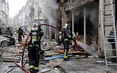 Firefighters intervene after the explosion of a bakery on the corner of the streets Saint-Cecile and Rue de Trevise in central Paris on January 12, 2019. (Thomas Samson/AFP)