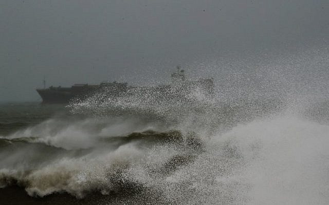 A picture taken on January 16, 2019 shows a cargo ship amidst high waves off of the Lebanese coast in the capital Beirut. (Photo by JOSEPH EID / AFP)