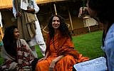 Sadhvi Bhagawati Saraswati, center, the US general secretary of the Global Interfaith WASH Alliance, talks to followers inside her camp at the Kumbh Mela festival in Allahabad, India, January 16, 2019. (CHANDAN KHANNA/AFP)