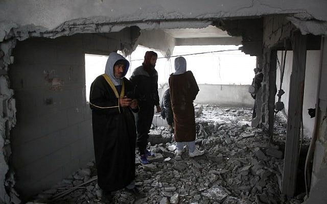 Palestinians checks the house of man accused of the fatal September stabbing of an Israeli-American, after it was partially demolished by Israeli forces on January 18, 2019, in the village of Yatta in the West Bank (HAZEM BADER / AFP) Palestinians checks the house of man accused of the fatal September stabbing of an Israeli-American, after it was partially demolished by Israeli forces on January 18, 2019, in the village of Yatta in the West Bank (HAZEM BADER / AFP)