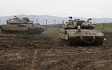 Israeli army Merkava tanks take positions on the Golan Heights, on January 20, 2019. (Jalaa Marey/AFP)
