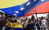 Venezuelan opposition supporters take part in a march on the anniversary of the 1958 uprising that overthrew the military dictatorship in Caracas on January 23, 2019. (Federico Parra / AFP)